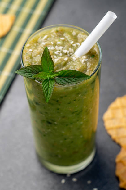 istock Vegetable green smoothie in a glass on a dark background 1169185729