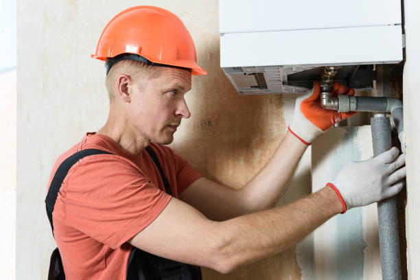 istock The worker is installing the gas boiler pipes. 1169185735
