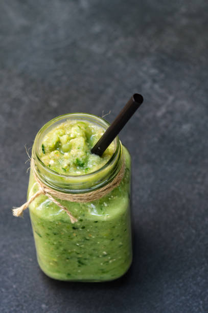 istock Vegetable green smoothie in a glass jar on a dark background 1169186570