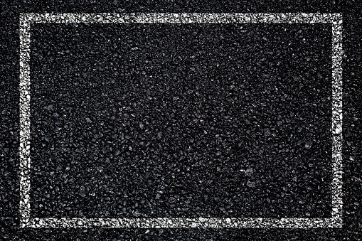 White intermittent dividing strip on asphalt.