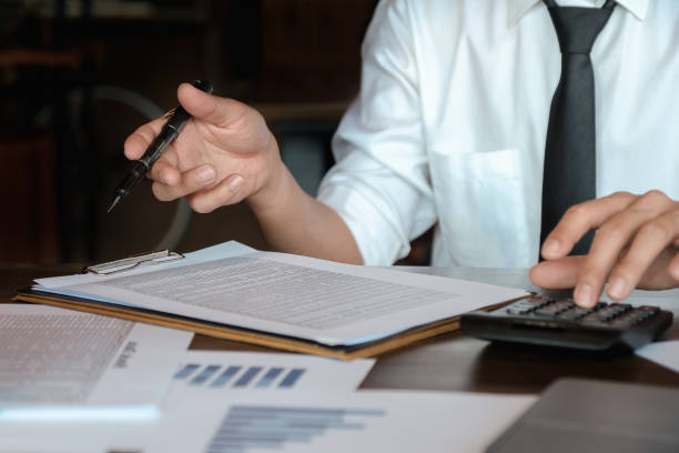 istock Economic research discussions, Business team analyzing income charts and graphs to plan marketing concept with using calculator  for analysis. 1169195831