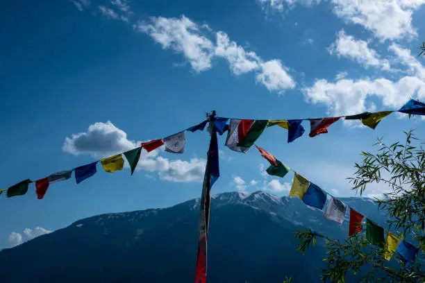 Photo of Budhist flags in the mountains near hamta