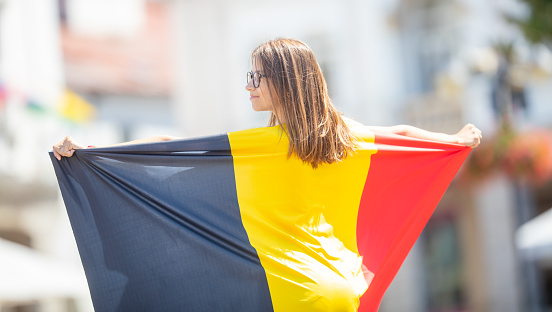Attractive happy young girl with the Belgian flag.