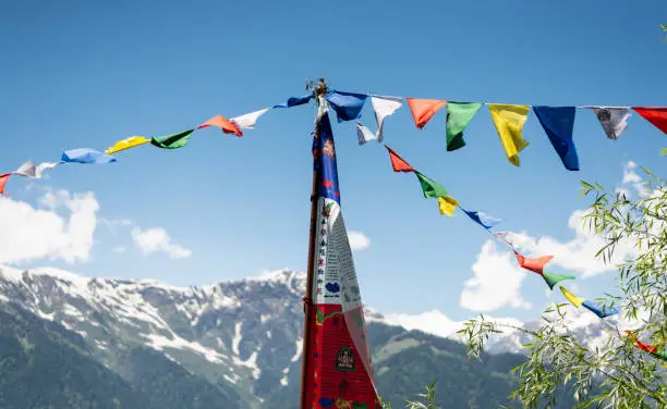 Photo of Budhist flags in the mountains near hamta