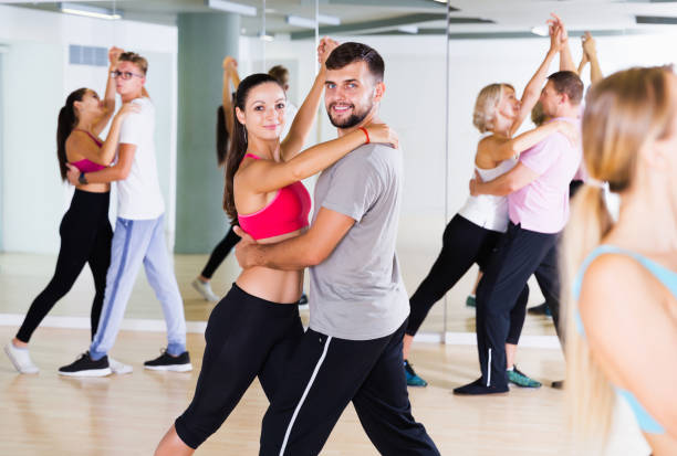 istock smiling young adults dancing salsa 1169202037