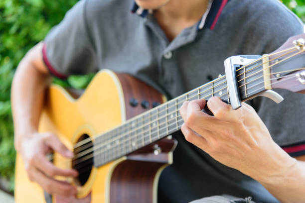 istock Playing acoustic guitar in the park 1169202168