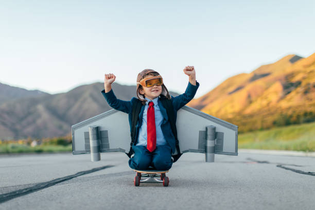 young boy geschäftsmann fliegen mit jet pack auf skateboard - taking off business creativity adventure stock-fotos und bilder