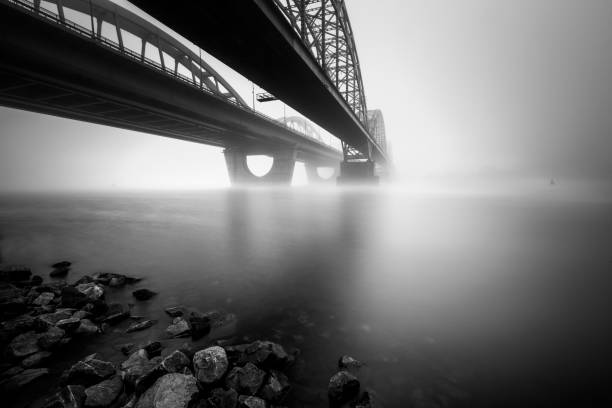 istock Two parallel bridges over foggy river. Long exposure shot. 1169203738
