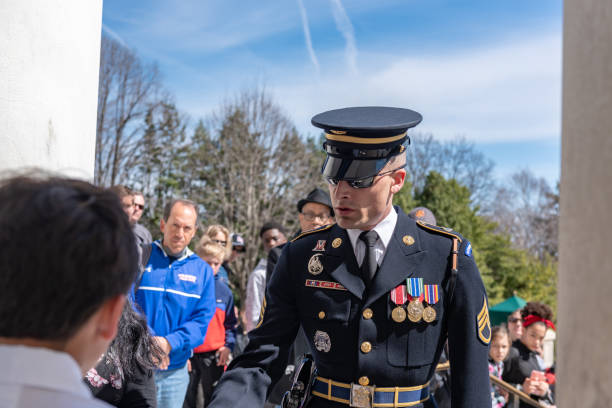 Changing of Guard Ceremony in Arlington National Cemetary during national cherry blossom festival, USA Tourists are watching the Changing of Guard Ceremony.
Arlington National Cemetery gravesite honoring the fallen in wars fought by Americans. arlington cemetery in spring stock pictures, royalty-free photos & images