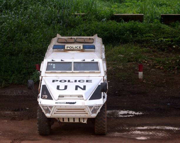UN Police armored vehicle protecting one of the entrances of Bangui, Central African Republic Bangui, Central African Republic: white UN Police armoured vehicle protecting one of the city's entrances armored vehicle photos stock pictures, royalty-free photos & images