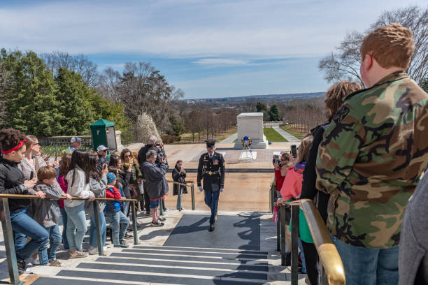 Changing of Guard Ceremony in Arlington National Cemetary during national cherry blossom festival, USA Tourists are watching the Changing of Guard Ceremony.
Arlington National Cemetery gravesite honoring the fallen in wars fought by Americans. arlington cemetery in spring stock pictures, royalty-free photos & images