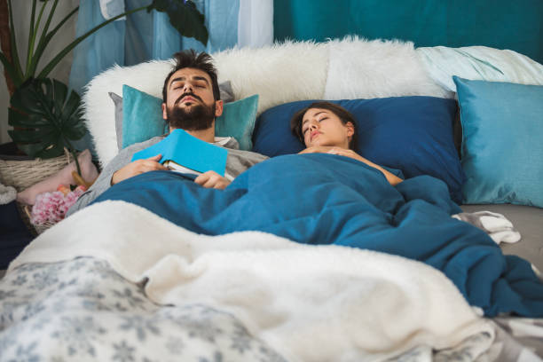 istock Couple sleeping in comfortable bed, covered with cozy blankets 1169205424