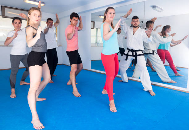 istock Adults trying new martial moves at karate class 1169207813