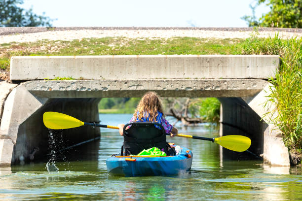istock Girl Kayaking Through Tunnel Under Road 1169209486