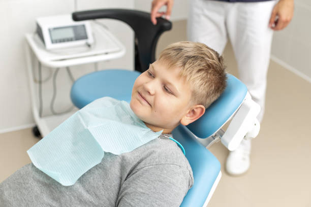 istock Blond little boy lays on dentist couch 1169211041