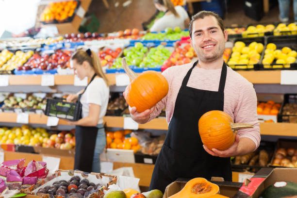 istock Nice man with pumpkin in hands 1169211139