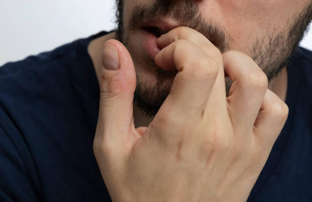 istock Nervous male biting fingernails  over isolated background 1169212381