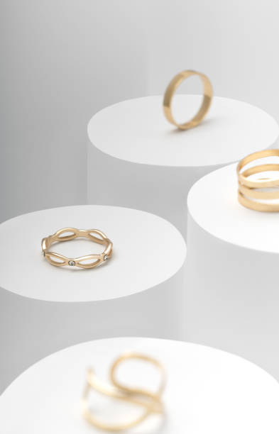 istock Modern Golden rings set on white cylinders top view 1169214509