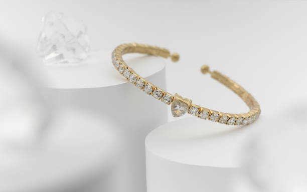istock Golden and diamond heart shape bracelet on white background 1169214566