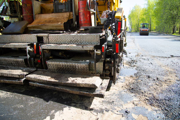istock Repair of roads.  Laying asphalt using a roller. 1169214584