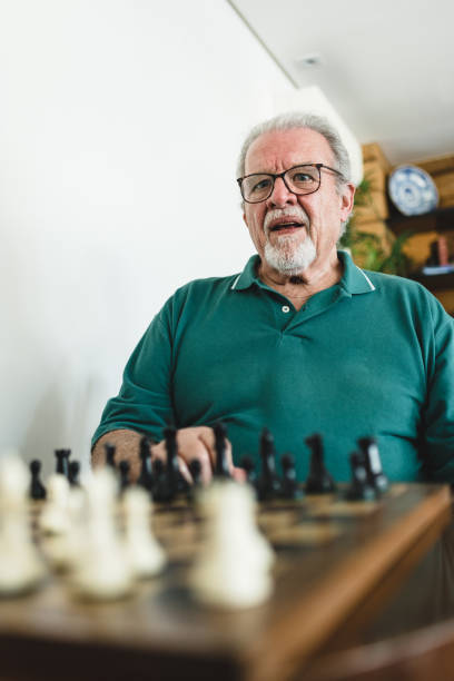 istock Elderly man in doubt playing chess 1169214785