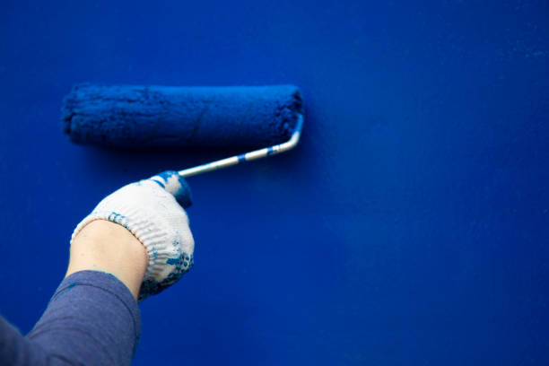 istock The painter paints the wall with a roller. 1169215126
