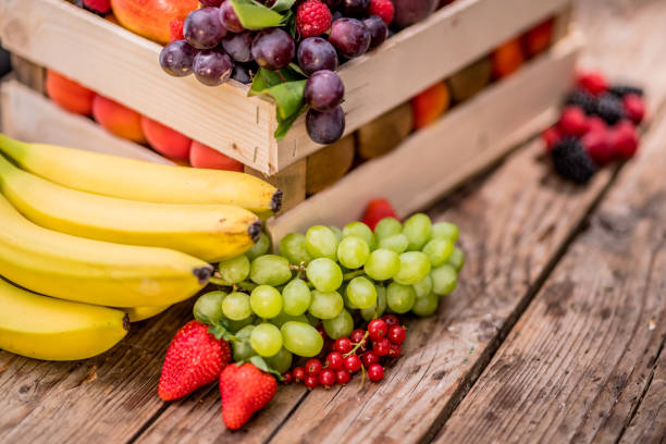 Close up of a wooden crate full of variety of  colourful fruits.