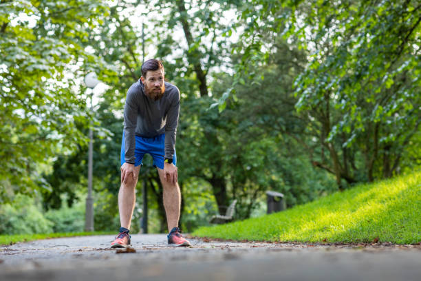 istock Man jogging in a park 1169225293