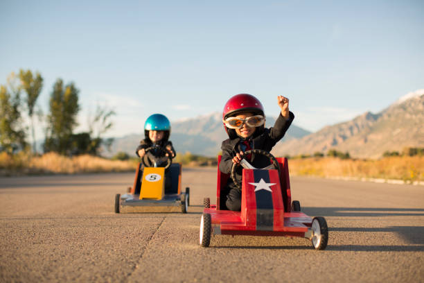 istock Young Business Boy Winning Car Race 1169225295
