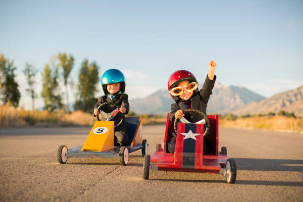 istock Young Business Boy Winning Car Race 1169225324