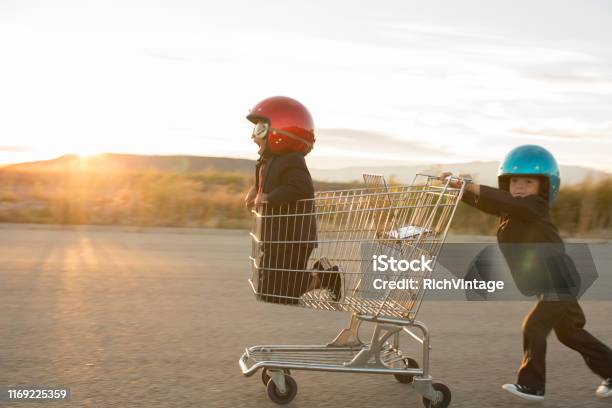 Young Business Boys Racing A Shopping Cart Stock Photo - Download Image Now - The Way Forward, Child, On The Move