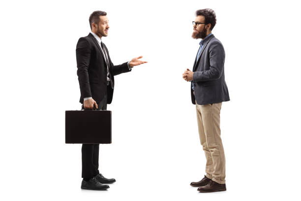 istock Young businessman with a suitcase explaining to a bearded man 1169225998