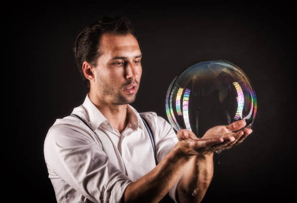 istock Artist hold big soap bubble in his hands. Bubble show studio concept. 1169227063
