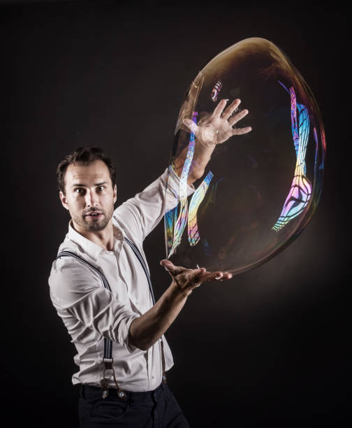 istock Artist hold big soap bubble in his hands. Bubble show studio concept. 1169227267