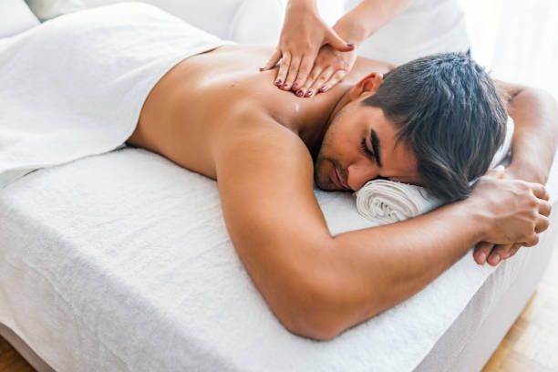 istock Man receiving back massage from masseur in spa 1169227836