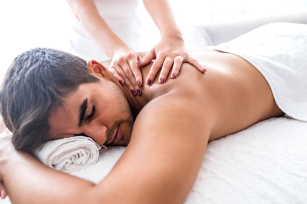 istock Man receiving back massage from masseur in spa 1169227849