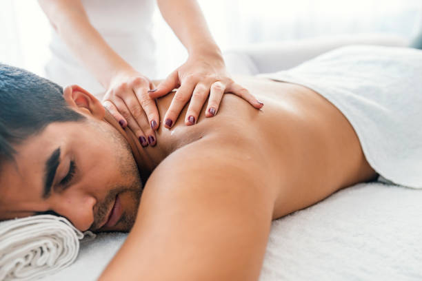 istock Young man is enjoying massage on spa treatment 1169228563