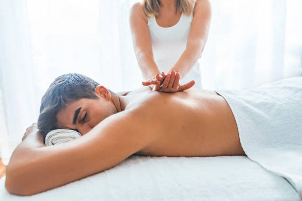 istock Man relaxing on massage table receiving massage. 1169228601