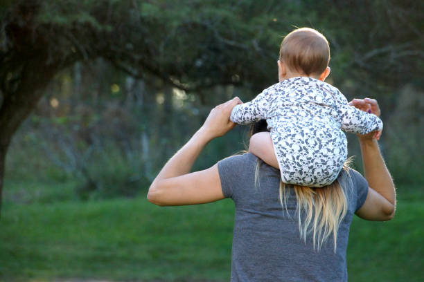 istock mother with baby on her back 1169228653