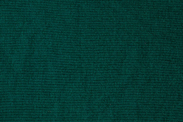 istock Dark green background from a textile material. Fabric with natural texture. Cloth backdrop 1169231855