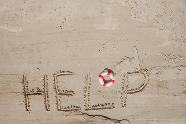 istock Help me the inscription on the sand. Please help me. On a tropical beach 1169231963