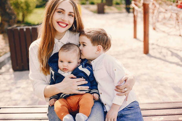 istock Mother with two children playing in a summer park 1169237692