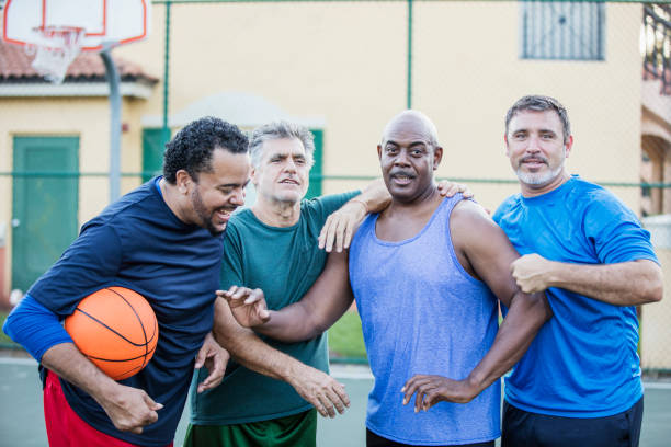 istock Multi-ethnic group of middle aged men playing basketball 1169239475