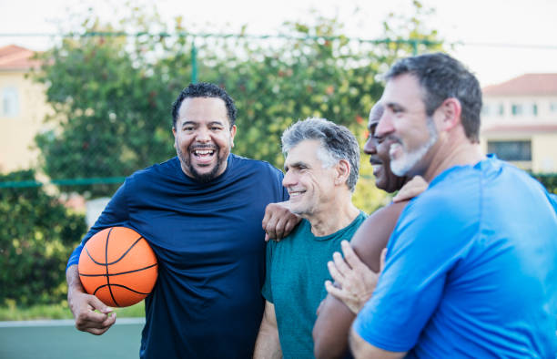 istock Multi-ethnic group of middle aged men playing basketball 1169239544