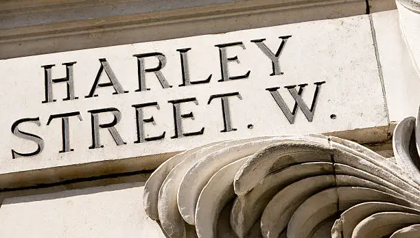 Close-up of the stone Harley street sign. Harley street has a world-wide reputation as a centre for private medical excellence with an extensive choice of specialists, clinics and private hospitals. 