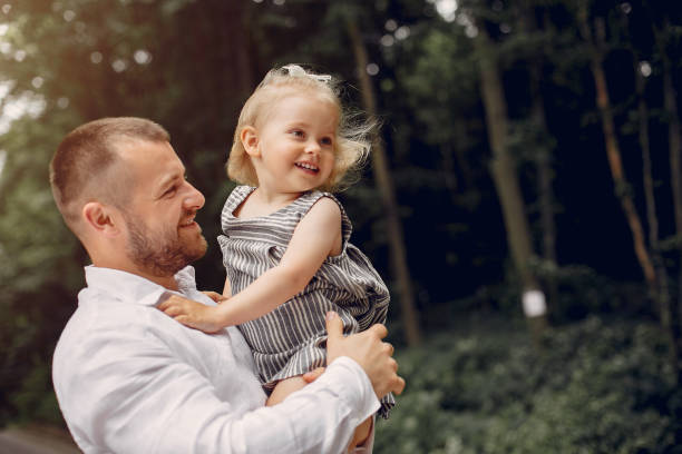 istock Family with daughter playing in a park 1169240314