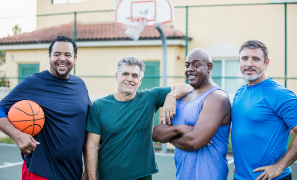 istock Multi-ethnic group of middle aged men playing basketball 1169240407