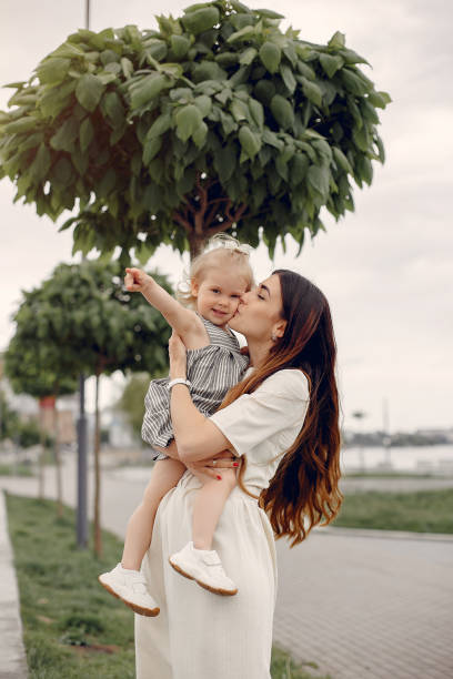 istock Mother with daughter playing in a summer park 1169240420