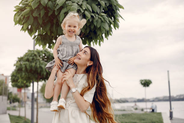 istock Mother with daughter playing in a summer park 1169240430