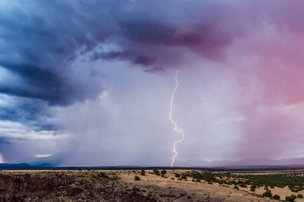 Thunderstorm with lightning strike Thunderstorm with heavy rain and lightning bolt strike in Wupatki National Monument, Arizona, USA. storm cloud sky dramatic sky cloud stock pictures, royalty-free photos & images